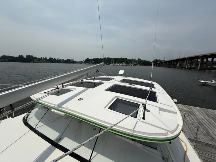 Two Fish Yacht Photos Pics 2021 Antares 44GS yacht docked by a river with bridge in background.