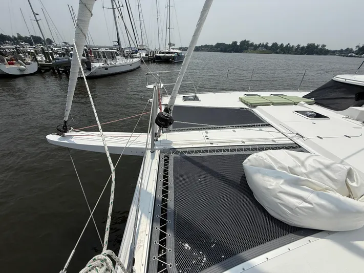 Two Fish Yacht Photos Pics 2021 Antares 44GS catamaran docked at marina, featuring spacious deck and netting.