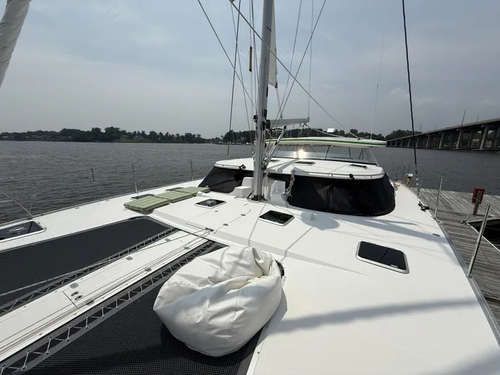 Two Fish Yacht Photos Pics 2021 Antares 44GS catamaran docked by a serene waterfront.