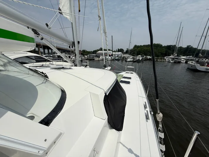 Two Fish Yacht Photos Pics Sailing yacht Antares 44GS, 2021 model, docked in a marina with other boats.