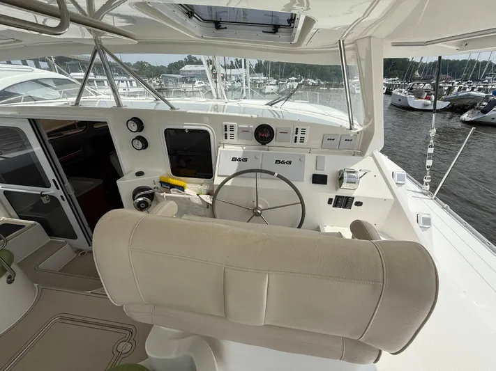 Two Fish Yacht Photos Pics Helm of 2021 Antares 44GS yacht with steering wheel and navigation instruments.