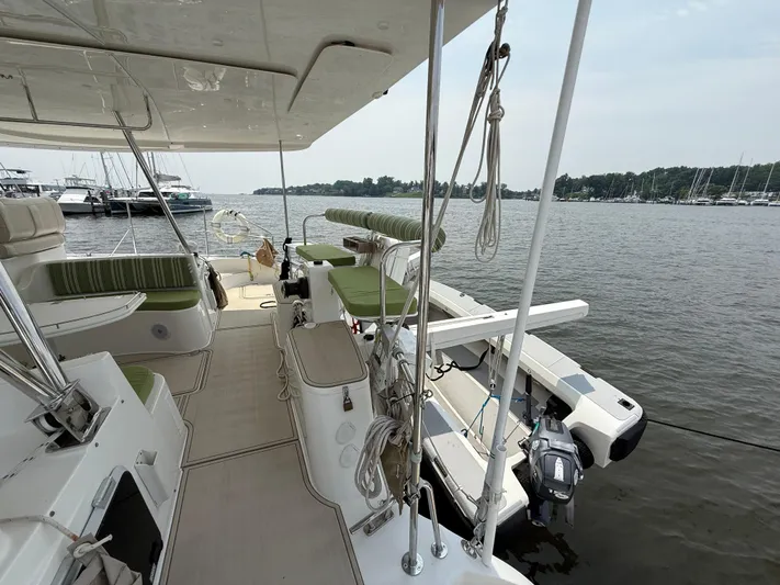 Two Fish Yacht Photos Pics Sleek 2021 Antares 44GS yacht docked by the water, showcasing spacious deck and seating.