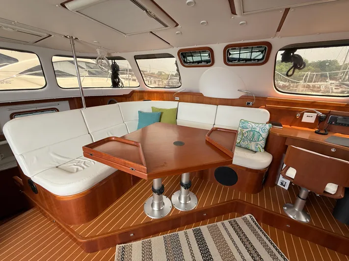 Two Fish Yacht Photos Pics Luxurious interior of 2021 Antares 44GS yacht with elegant wood and white seating.