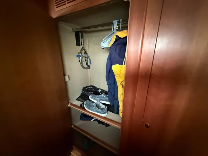 Two Fish Yacht Photos Pics Wooden closet interior with clothes and shoes, Antares 44GS 2021 model.