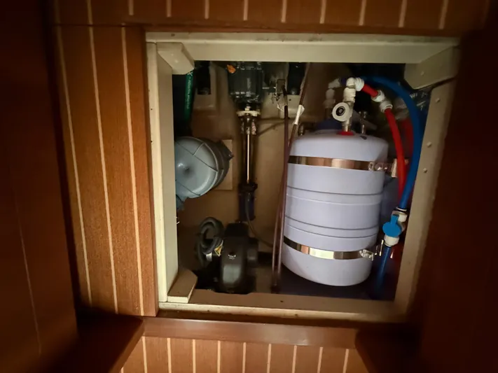 Two Fish Yacht Photos Pics Engine compartment of 2021 Antares 44GS yacht, featuring mechanical and plumbing components.