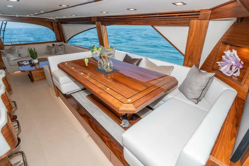 Zatara Yacht Photos Pics Luxurious interior of 2025 Viking 90 Convertible yacht with elegant wood and ocean view.