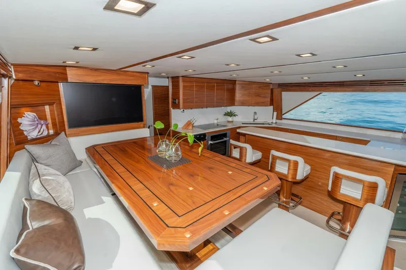 Zatara Yacht Photos Pics Luxurious interior of 2025 Viking 90 Convertible yacht with elegant wood finishes and modern amenities.