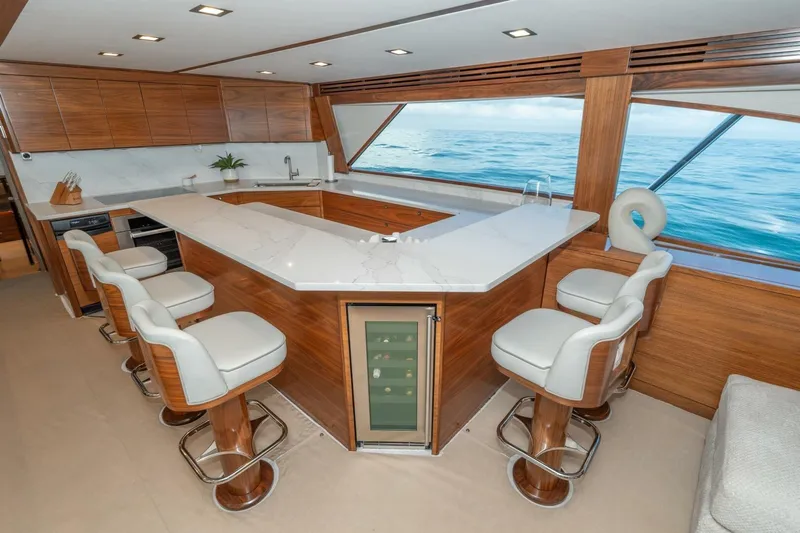 Zatara Yacht Photos Pics Luxurious interior of 2025 Viking 90 Convertible yacht with modern kitchen and ocean view.