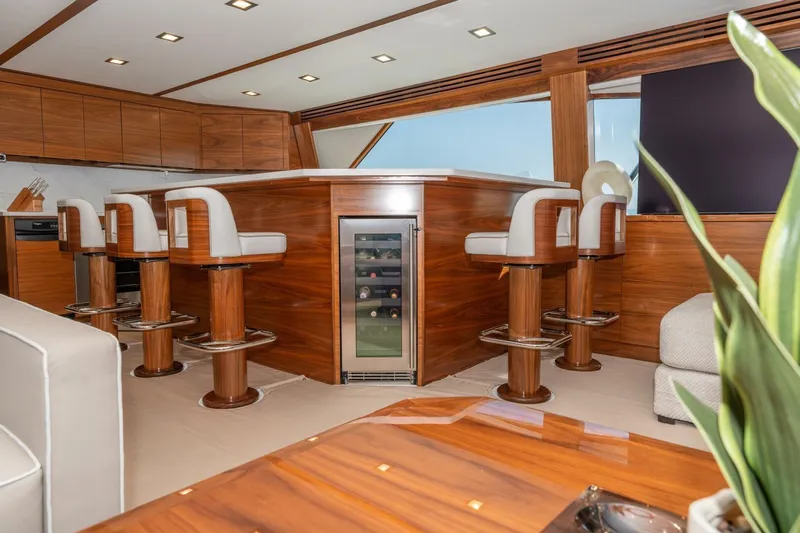 Zatara Yacht Photos Pics Luxurious interior of 2025 Viking 90 Convertible yacht with elegant bar and seating.