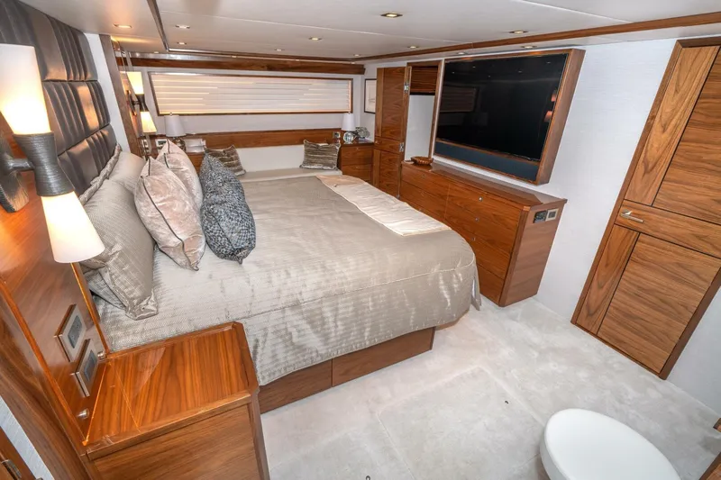 Zatara Yacht Photos Pics Luxurious bedroom interior of 2025 Viking 90 Convertible yacht with elegant wood finishes.