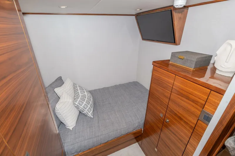 Zatara Yacht Photos Pics Cozy cabin interior of 2025 Viking 90 Convertible yacht with modern wood finish.