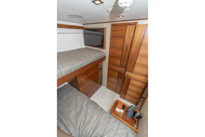 Zatara Yacht Photos Pics 2025 Viking 90 Convertible yacht interior with wooden cabinetry and bunk beds.