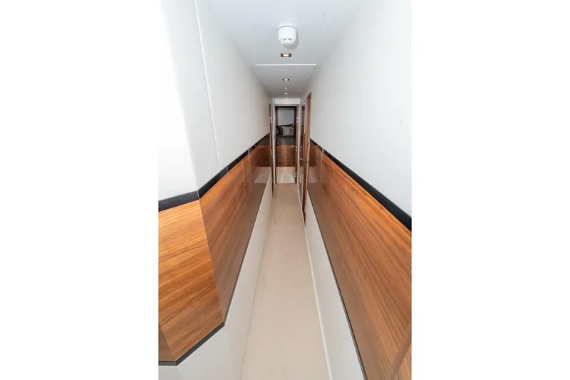 Zatara Yacht Photos Pics Narrow hallway with wood paneling inside 2025 Viking 90 Convertible yacht.
