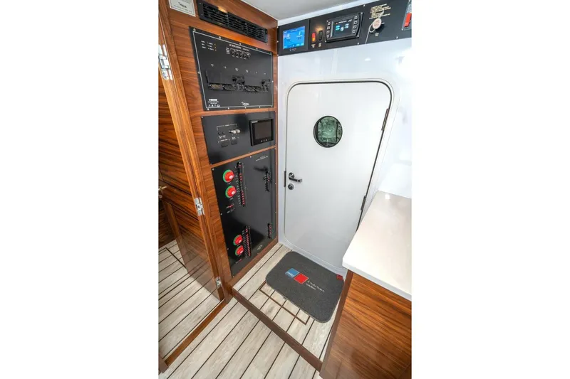 Zatara Yacht Photos Pics Interior of 2025 Viking 90 Convertible yacht with control panels and wooden flooring.