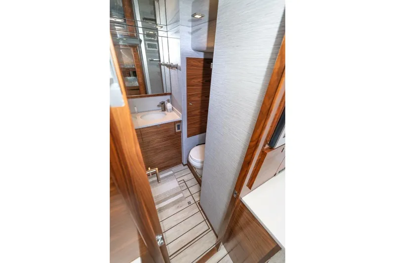 Zatara Yacht Photos Pics Luxurious bathroom in 2025 Viking 90 Convertible yacht with modern fixtures and wood accents.