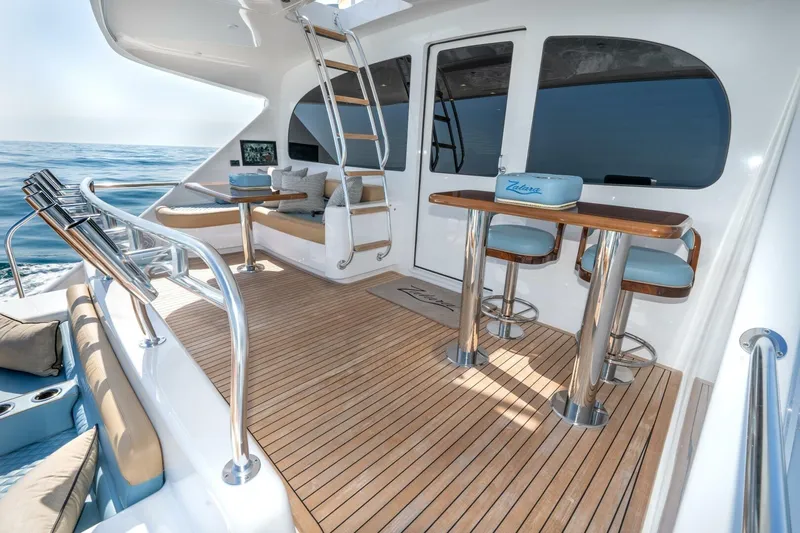 Zatara Yacht Photos Pics Luxurious deck of 2025 Viking 90 Convertible yacht with elegant seating and ocean view.