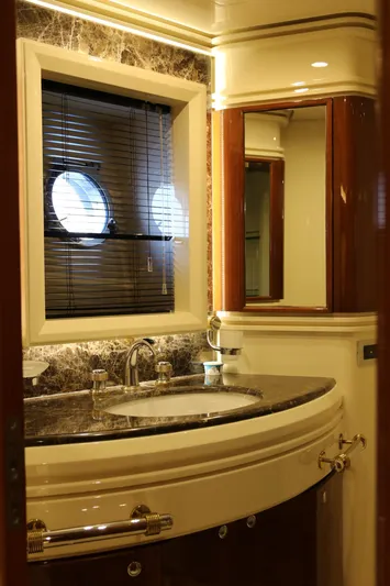 Simona Yacht Photos Pics Luxurious bathroom interior of 2003 Azimut 98 Leonardo yacht with elegant fixtures and porthole window.
