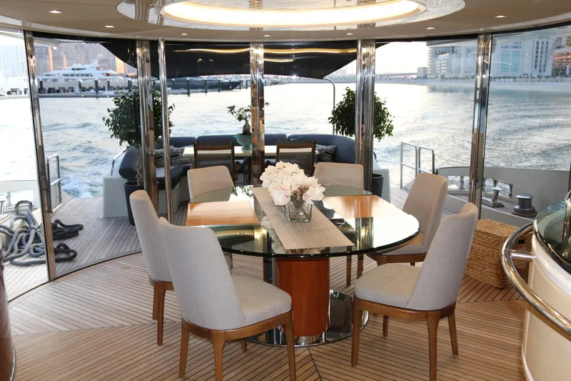 Simona Yacht Photos Pics Luxurious dining area on 2003 Azimut 98 Leonardo yacht with elegant decor and waterfront view.