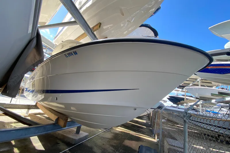  Yacht Photos Pics 2008 Hydra-Sports Vector 2900 CC boat in storage, side view with blue stripe.