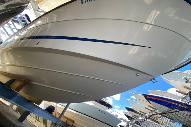  Yacht Photos Pics 2008 Hydra-Sports Vector 2900 CC boat hull in storage, showcasing sleek design and blue stripe.