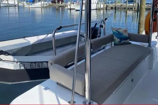 Nauti Habit Yacht Photos Pics Bali 4.2 boat, 2023 model, docked with cushioned seating and decorative pillow.