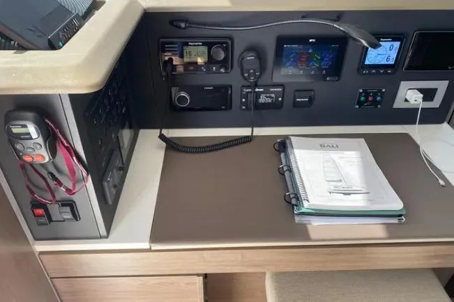 Nauti Habit Yacht Photos Pics Control panel of a 2023 Bali 4.2 yacht with navigation equipment and manual.