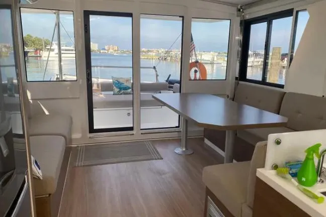 Nauti Habit Yacht Photos Pics Interior of 2023 Bali 4.2 catamaran with spacious seating and waterfront view.