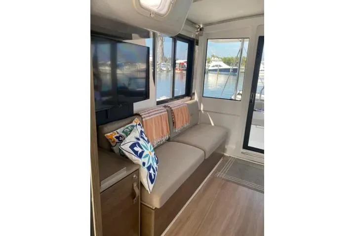 Nauti Habit Yacht Photos Pics Interior of 2023 Bali 4.2 yacht with cozy seating, pillows, and marina view.