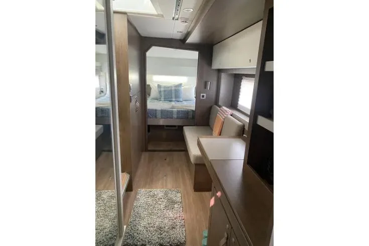 Nauti Habit Yacht Photos Pics Modern interior of 2023 Bali 4.2 yacht with cozy seating and bed area.