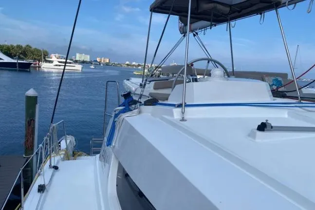 Nauti Habit Yacht Photos Pics 2023 Bali 4.2 yacht docked at marina with scenic waterfront view.