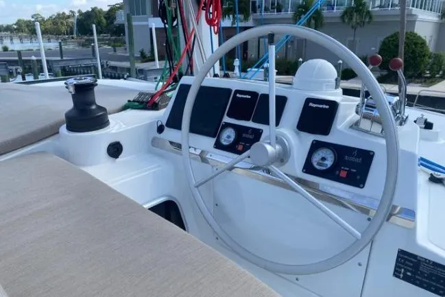 Nauti Habit Yacht Photos Pics Steering wheel and control panel of 2023 Bali 4.2 yacht, docked at marina.