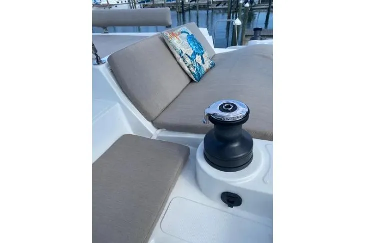 Nauti Habit Yacht Photos Pics Luxurious Bali 4.2 yacht deck with cushioned seating and decorative pillow, 2023 model.