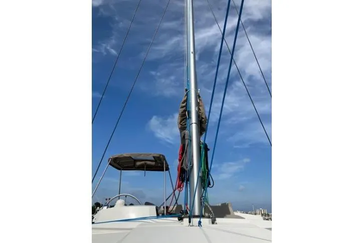 Nauti Habit Yacht Photos Pics Sailboat mast with ropes against a blue sky, Bali 4.2 model, 2023.