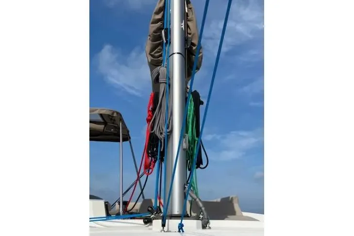 Nauti Habit Yacht Photos Pics Sailboat mast with colorful ropes on a 2023 Bali 4.2 under a clear blue sky.