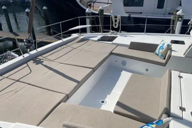 Nauti Habit Yacht Photos Pics Luxurious 2023 Bali 4.2 yacht deck with beige seating and nautical decor.