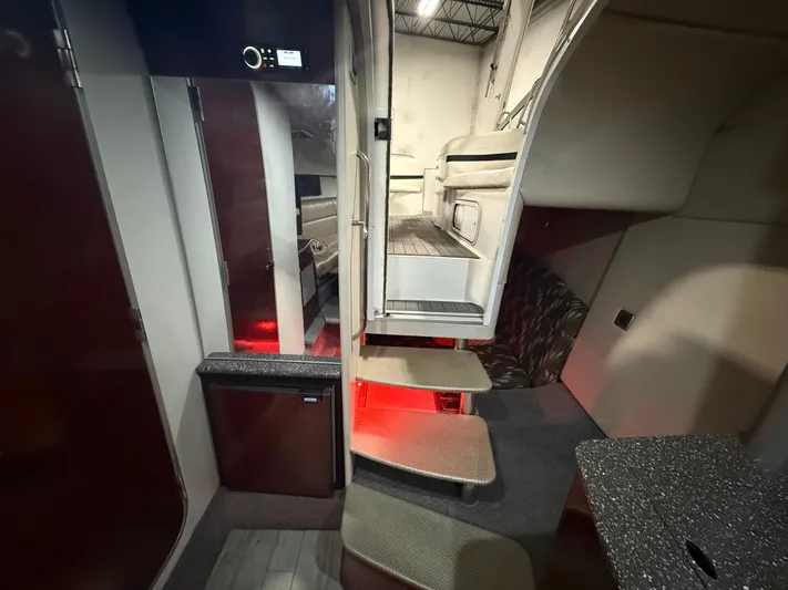 Prime Time Yacht Photos Pics Interior of a 2005 Formula 370 Super Sport yacht with stairs and seating area.