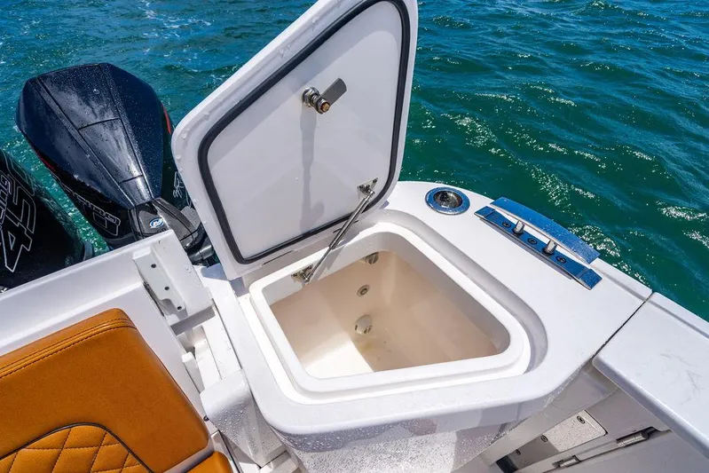  Yacht Photos Pics Open storage compartment on 2021 Intrepid 477 Evolution boat, with ocean backdrop.