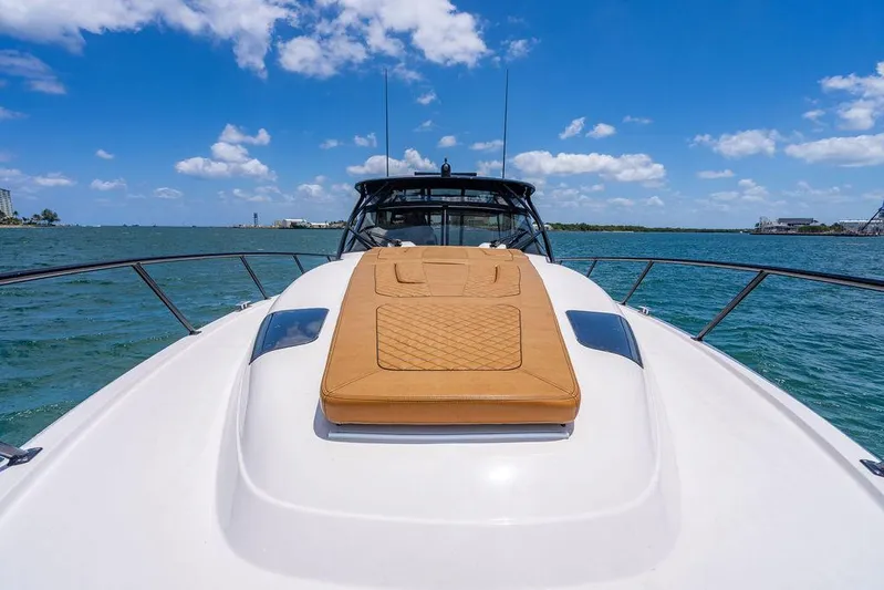  Yacht Photos Pics 2021 Intrepid 477 Evolution yacht on water, featuring sleek design and sunny deck.