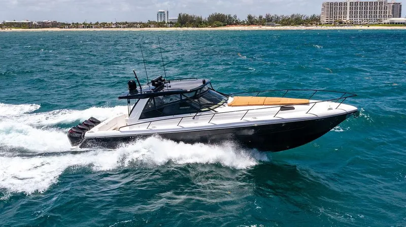  Yacht Photos Pics 2021 Intrepid 477 Evolution cruising on ocean near coastline.