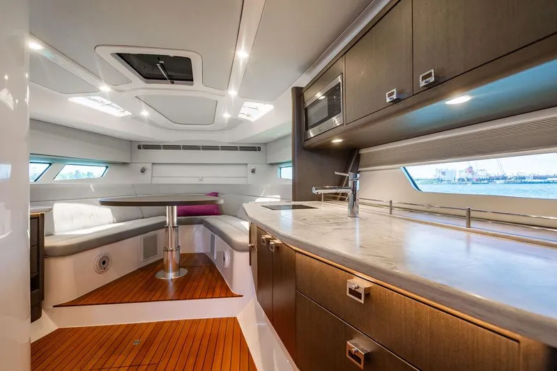  Yacht Photos Pics Interior of 2021 Intrepid 477 Evolution yacht with modern kitchen and seating area.