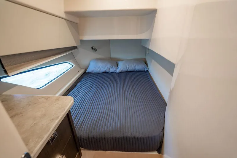  Yacht Photos Pics 2021 Intrepid 477 Evolution cabin with cozy bed and window view.