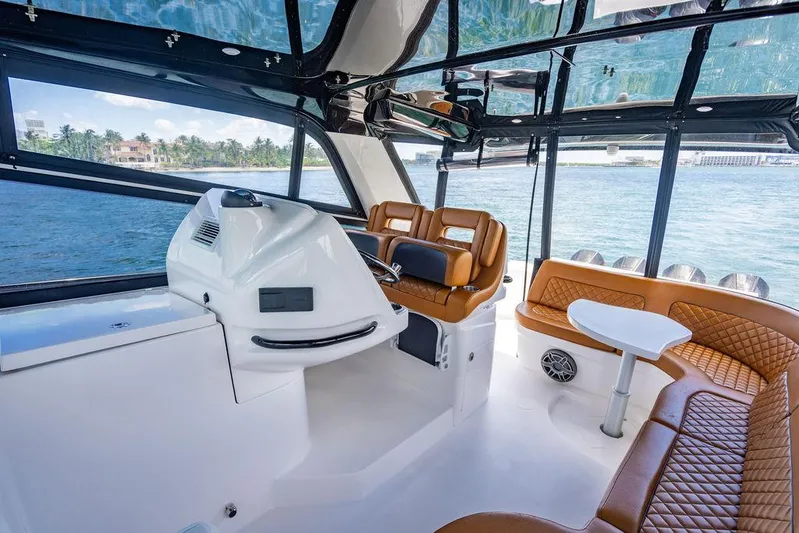  Yacht Photos Pics Luxurious interior of 2021 Intrepid 477 Evolution yacht with leather seating and modern helm.