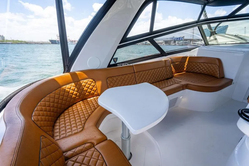  Yacht Photos Pics Luxurious interior of 2021 Intrepid 477 Evolution yacht with leather seating and ocean view.