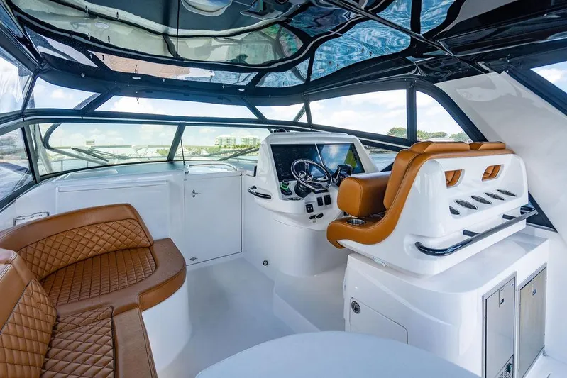  Yacht Photos Pics Luxurious interior of 2021 Intrepid 477 Evolution yacht with leather seating and modern helm.