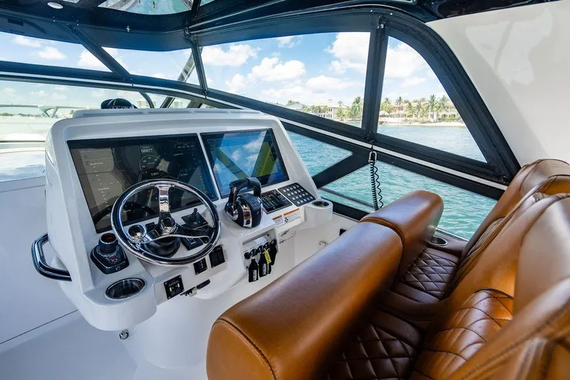  Yacht Photos Pics 2021 Intrepid 477 Evolution helm with leather seats and advanced navigation system.