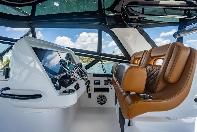  Yacht Photos Pics Interior of 2021 Intrepid 477 Evolution yacht with leather seats and modern dashboard.