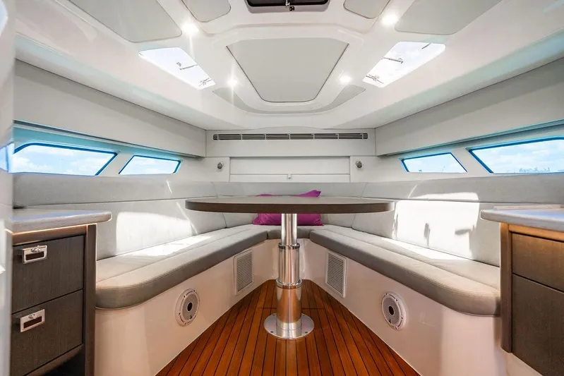 Yacht Photos Pics Luxurious interior of 2021 Intrepid 477 Evolution yacht with elegant seating and wooden flooring.