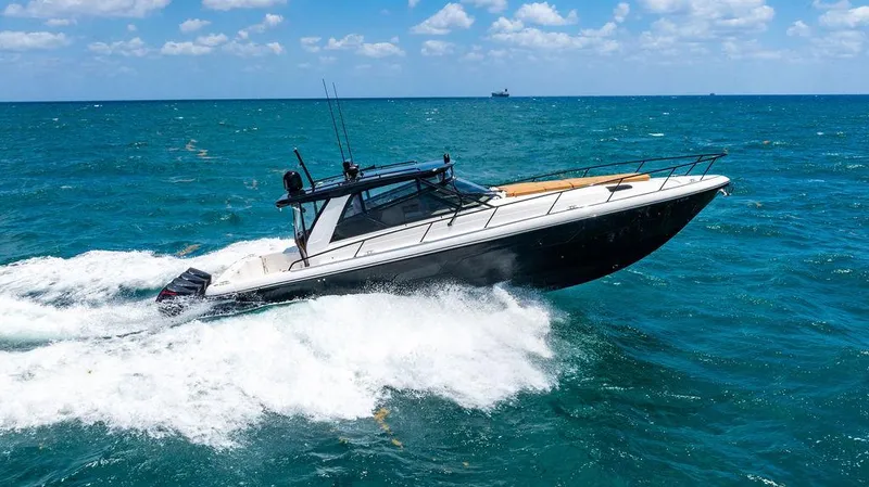  Yacht Photos Pics Intrepid 477 Evolution 2021 cruising on blue ocean waves under a clear sky.