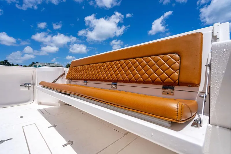  Yacht Photos Pics Luxurious leather seating on 2021 Intrepid 477 Evolution boat under a clear blue sky.