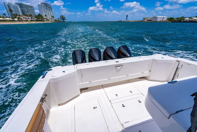  Yacht Photos Pics 2021 Intrepid 477 Evolution boat cruising on blue ocean with four engines.